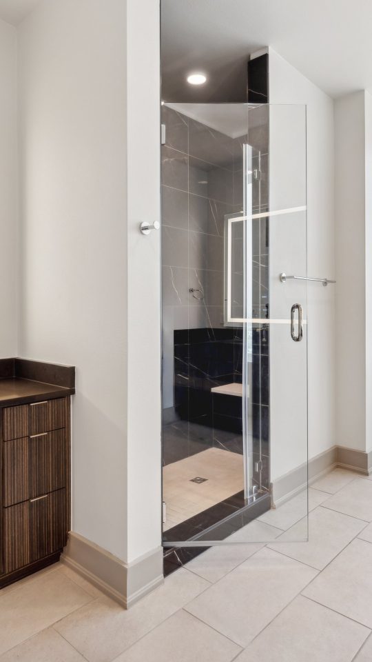 a bathroom with a large window and a large mirror at The LVL 29